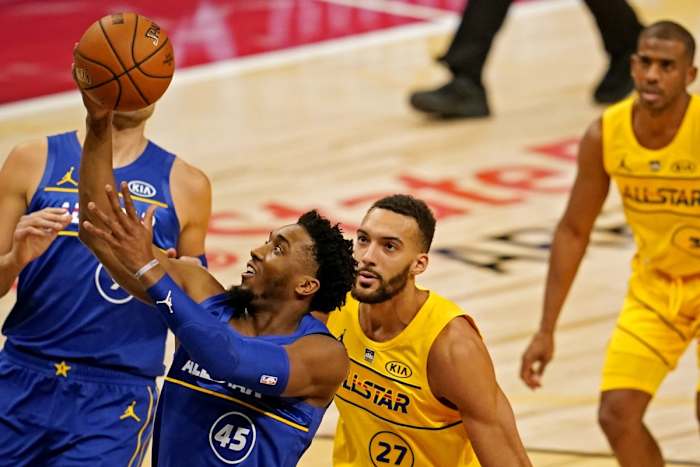 Donovan Mitchell (45) scores a layup over Jazz teammate Rudy Gobert (27)